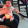Tevon Xavier Brown joined the competition — help win amazing prizes! baby, infant, person, hand, cushion, socks, clothing, indoor, carpet, chair, couch, photograph, portrait, human, holding, seated, furniture, living_room, curly_hair, expression