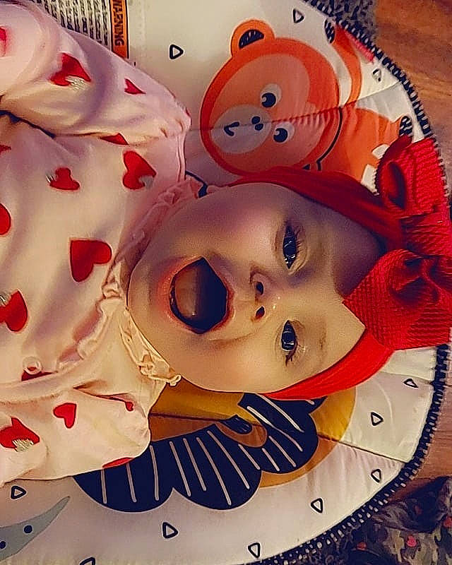 Parker is registered to the contest to win money with this photo: art, carmine, cheek, child, chin, circle, eyelash, fictional_character, font, happy, headwear, ornament, pattern, person, pink, plastic, porcelain, red, sweetness, toy