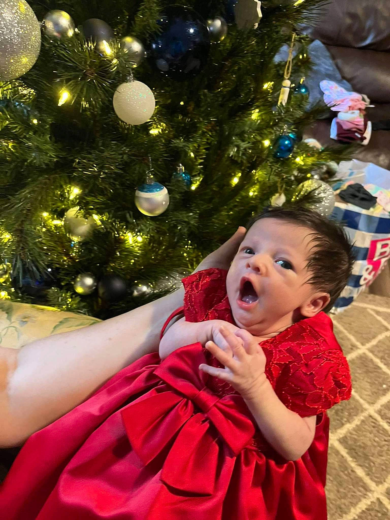 Caroline joined the competition — help win amazing prizes! child, christmas, christmas_decoration, christmas_eve, christmas_ornament, christmas_tree, dress, event, fun, gesture, happy, holiday, holiday_ornament, lighting, ornament, people_in_nature, person, sitting, toddler, tradition