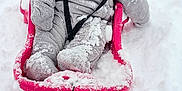 Timeo a rejoint le concours — aidez-le/la à gagner de superbes lots ! child, baby, sled, pink_sled, snow, winter, snowsuit, hat, bundle, rosy_cheeks, sitting, outdoors, rope, play, mittens, boots, adult, background, red_sled, snow_play