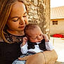 Timeo a rejoint le concours — aidez-le/la à gagner de superbes lots ! baby, newborn, woman, holding, affection, outdoor, stone_wall, necklace, black_lace_dress, bracelet, portrait, sunlight, roof, yard, cuddling, parenting, family, closeup, gentle, skin
