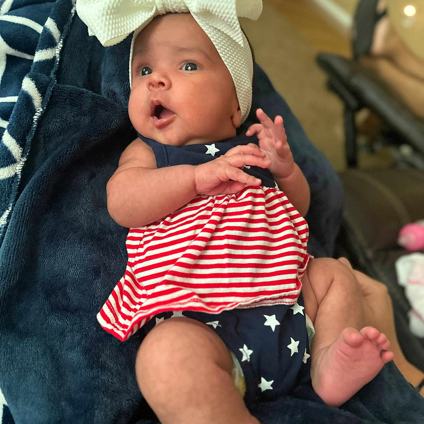 Mia joined the competition — help win amazing prizes! baby, blanket, bodypart, bonnet, clothing, couch, cushion, dress, face, finger, furniture, hand, hat, head, homedecor, newborn, person, photography, portrait, towel