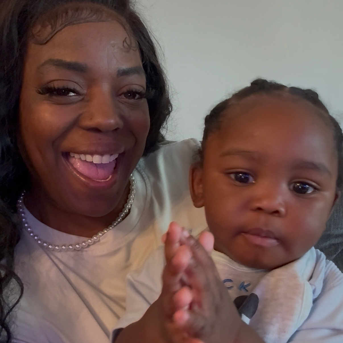 Charles joined the competition — help win amazing prizes! woman, toddler, child, smiling, clapping, indoor, person, family, happy, portrait, casual_clothing, pearl_necklace, hairstyle, closeup, skin, face, expression, baby, mother, bonding