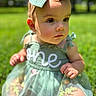 Kenzlee is registered to the contest to win money with this photo: baby, child, toddler, headband, bow, dress, green, grass, outdoor, sunlight, portrait, cute, young, nature, sitting, face, eyes, skin, fashion, summer