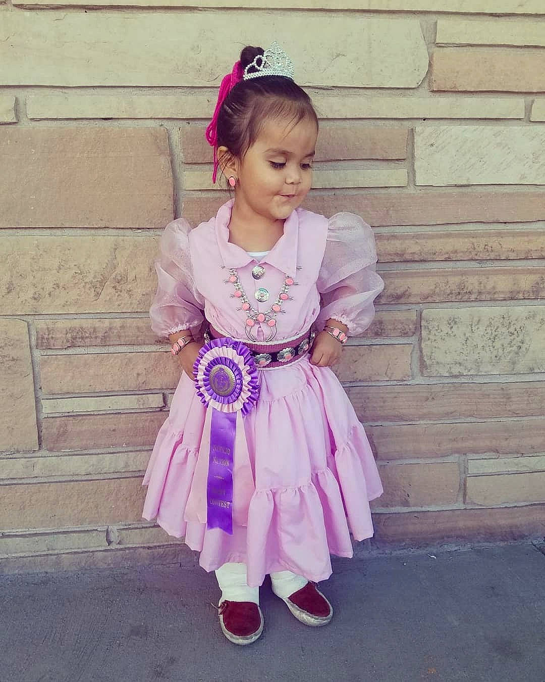 Melissa is registered to the contest to win money with this photo: baby_toddler_clothing, ballet_tutu, child, child_model, clothing, costume, dress, fashion_accessory, hair_accessory, headband, headpiece, lavender, person, pink, purple, shoe, smile, textile, toddler
