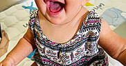 Shiloh is registered to the contest to win money with this photo: baby, child, smiling, happy, sitting, play_mat, indoor, patterned_clothing, denim_shorts, cute, face, portrait, infant, bright, eyes, skin, person, young_child, cheerful, expression