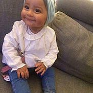 Inaya a rejoint le concours — aidez-le/la à gagner de superbes lots ! toddler, child, smiling, headband, bow, white_blouse, blue_jeans, nike_sneakers, sitting, couch, indoor, cute, happy, fashion, footwear, clothing, person, portrait, baby, casual