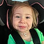 toddler, child, car_seat, green_shirt, smile, face, heterochromia, seatbelt, necklace, hair, young_child, portrait, safety, cute, indoors, close_up, happy, person, baby, head