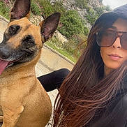 Saïka participe au concours pour gagner de l'argent avec cette photo : dog, person, outdoor, rocky_hill, flowers, grass, sunglasses, hoodie, long_hair, smiling_dog, happy, nature, casual, pet, animal, portrait, daylight, friendship, resting, ground