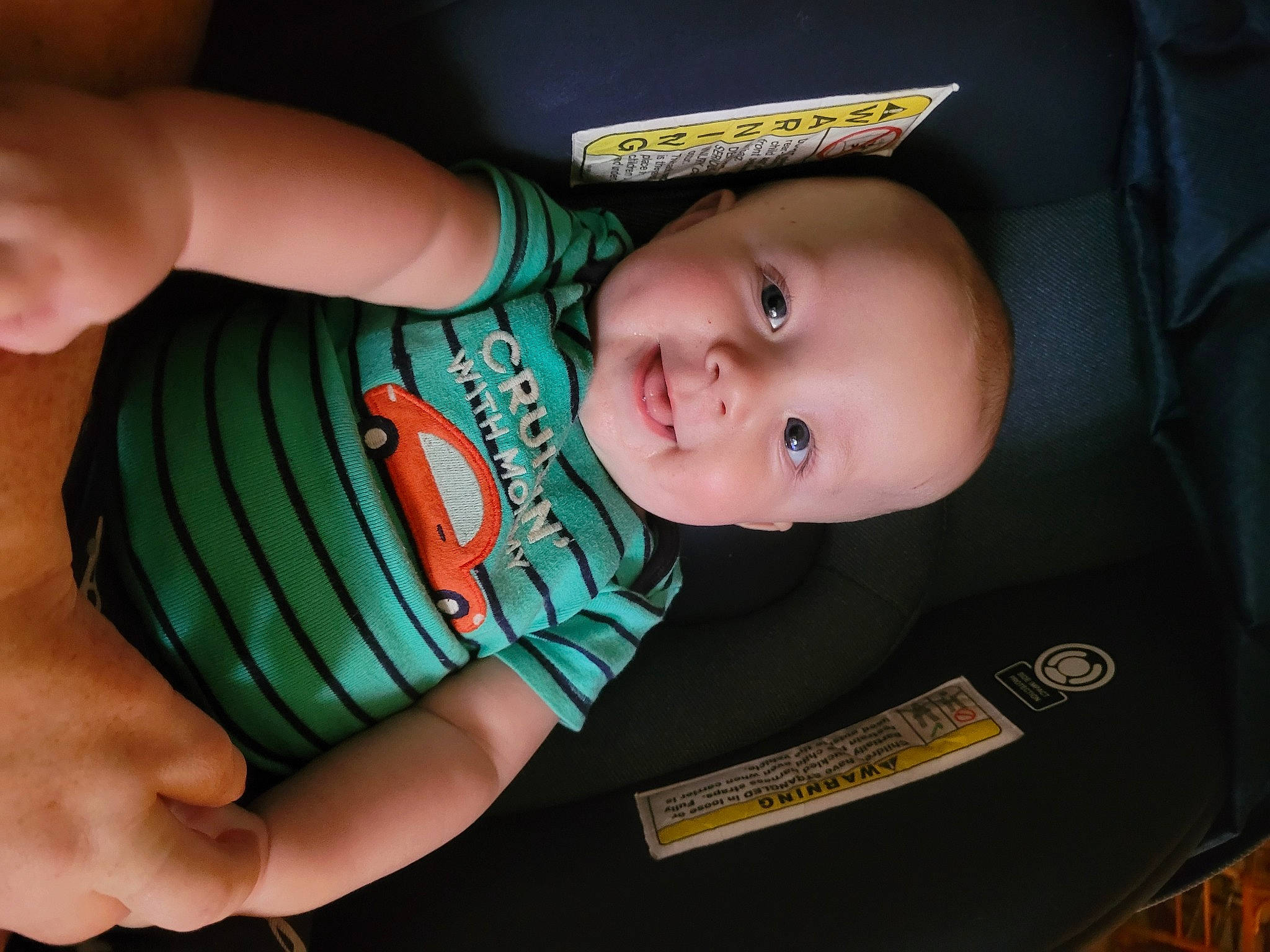 Levi is registered to the contest to win money with this photo: baby, baby_products, baby_toddler_clothing, cheek, child, elbow, facial_expression, finger, gesture, hand, happy, iris, nail, person, sitting, skin, sleeve, smile, thumb, toddler