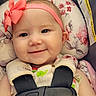 baby, infant, smiling, headband, pink_bow, car_seat, safety_harness, floral_pattern, cute, closeup, child, face, portrait, happy, seatbelt, clothing, person, baby_girl, indoor, comfort