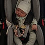 accessory, baby, blanket, car_seat, child, clothing, cozy, cute, hat, indoors, infant, newborn, pacifier, peaceful, person, safety, seat, sleeping, soft_lighting, straps