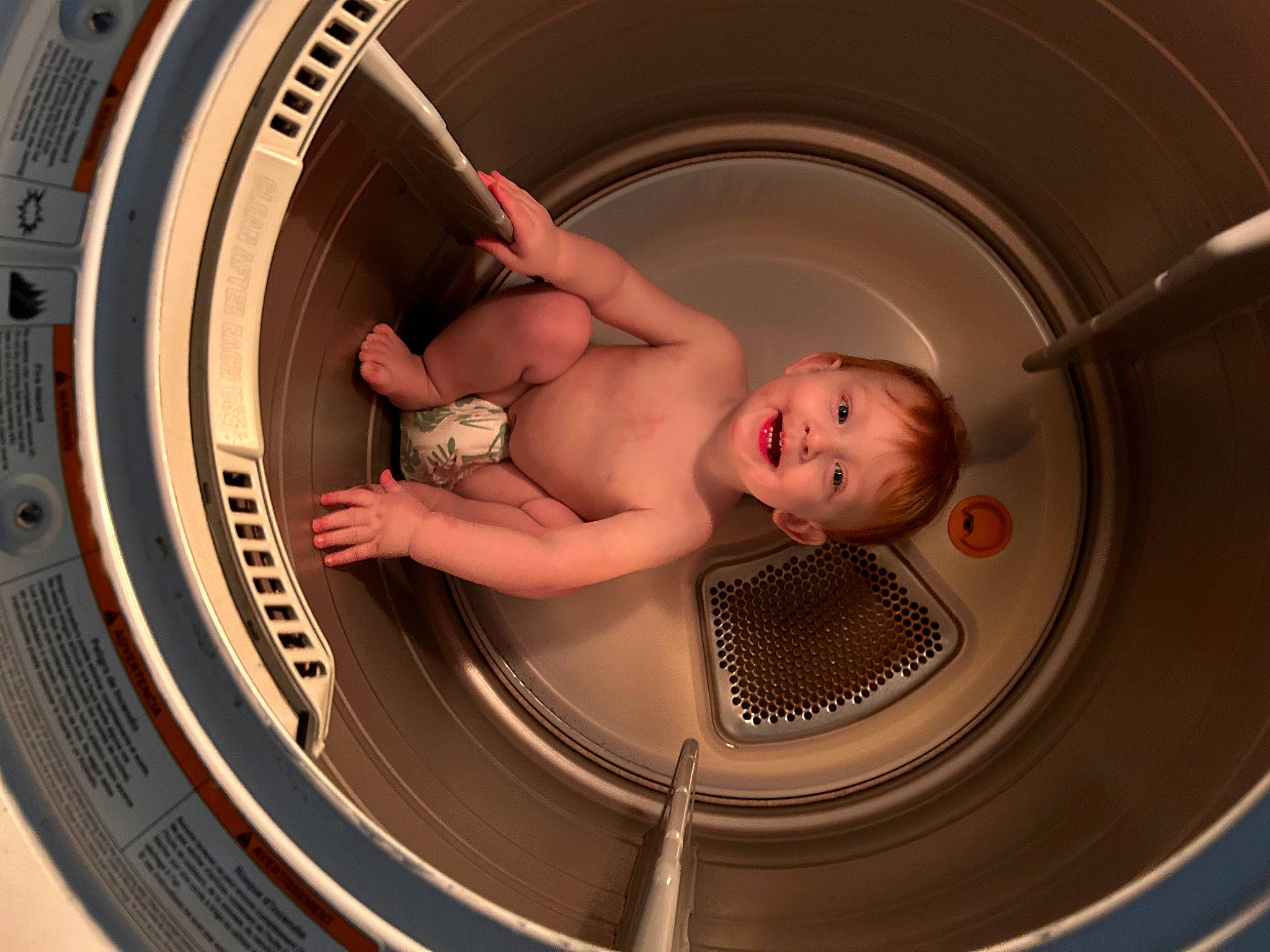 Jasper is registered to the contest to win money with this photo: arm, auto_part, automotive_tire, automotive_wheel_system, baby, bathing, chest, child, circle, comfort, elbow, eye, flash_photography, fun, human_body, leg, machine, person, rim, thigh