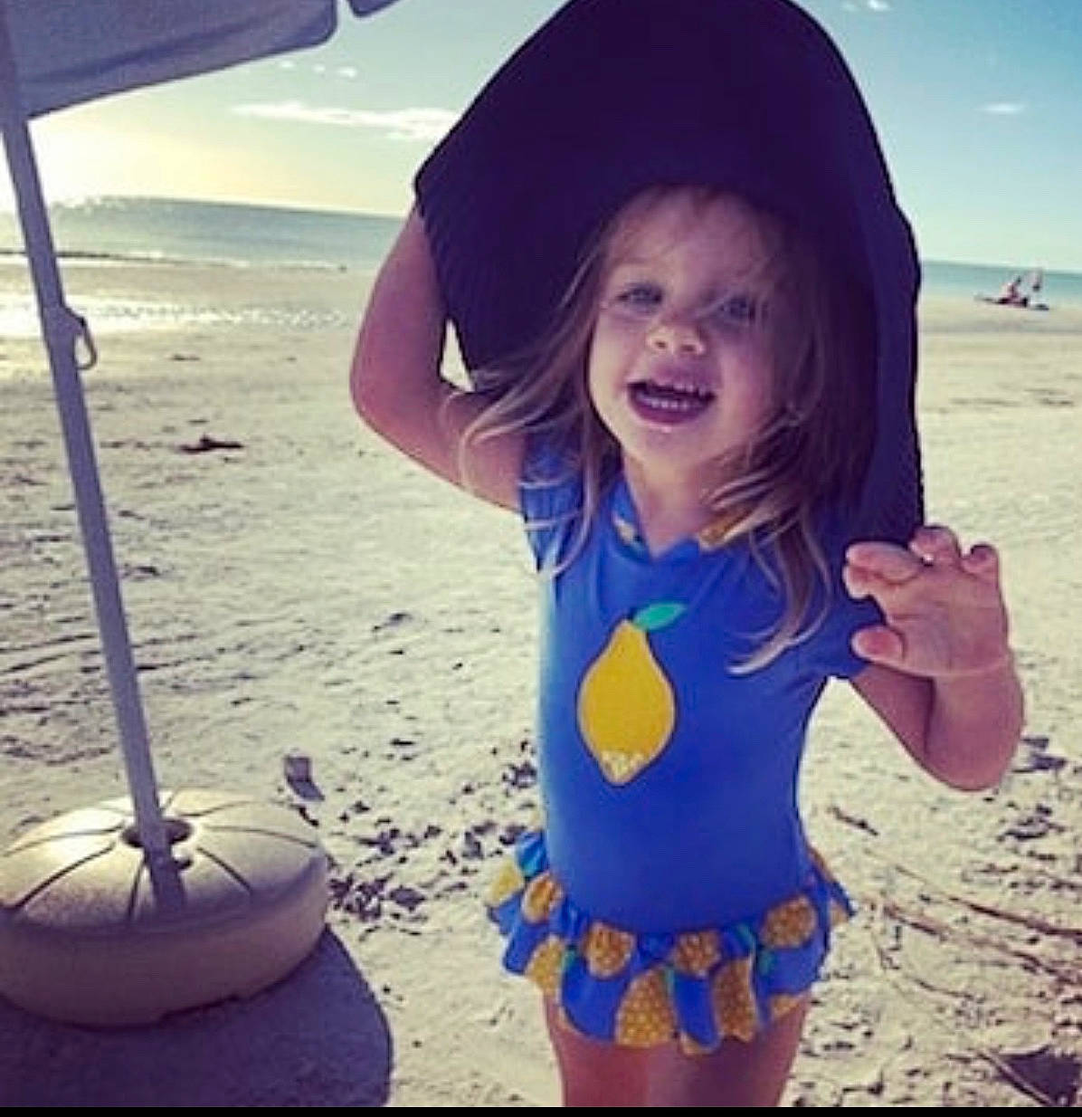 Audrey joined the competition — help win amazing prizes! azure, beach, cool, facial_expression, finger, fun, hairstyle, happy, hat, light, morning, organ, people_on_beach, person, photograph, sand, smile, standing, summer, sunlight