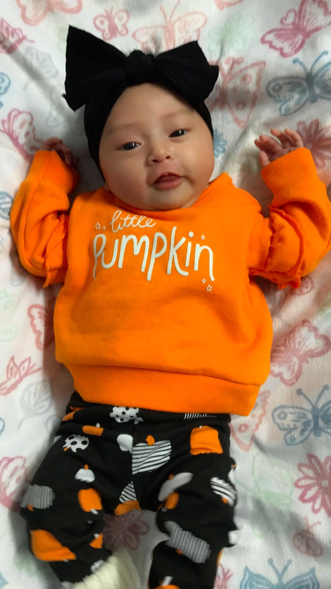 Lillyann is registered to the contest to win money with this photo: baby, baby_products, baby_toddler_clothing, cap, cheek, child, cool, eye, face, facial_expression, happy, headwear, orange, organ, outerwear, person, pink, skin, sleeve, t_shirt