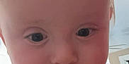 Bellamy joined the competition — help win amazing prizes! baby, close_up, face, child, curious, hair, indoor, infant, person, portrait, shirt, stain, wide_eyes, young, head, skin, expression, cute, cheeks, lighting