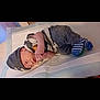 baby, blanket, child, clothing, comfort, cozy, cute, hat, indoor, infant, lying_down, newborn, nursery, peaceful, person, resting, sleeping, soft_surface, striped_socks, warm