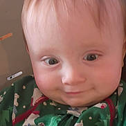 Bellamy joined the competition — help win amazing prizes! baby, child, face, smile, green_onesie, polar_bear_pattern, high_chair, light_hair, indoor, cute, expression, close_up, infant, cheeky, young_child, seated, clothing, person, portrait, babywear