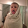 child, towel, bathroom, face, mouth_open, mirror, reflection, wet_hair, indoor, expression, person, portrait, home, fun, playful, young, cute, wrapped, soft, smile