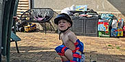 Léo a rejoint le concours — aidez-le/la à gagner de superbes lots ! child, boy, helmet, protective_gear, roller_skates, outdoor, backyard, brick_patio, toy_truck, chair, sunlight, casual, crouching, play, summertime, safety, plastic, clothing, fun, kid