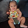 Ohana a rejoint le concours — aidez-le/la à gagner de superbes lots ! baby, child, smiling, sitting, couch, diaper, floral_top, cute, happy, indoors, furniture, person, skin, face, legs, arm, pillow, home, comfort, infant
