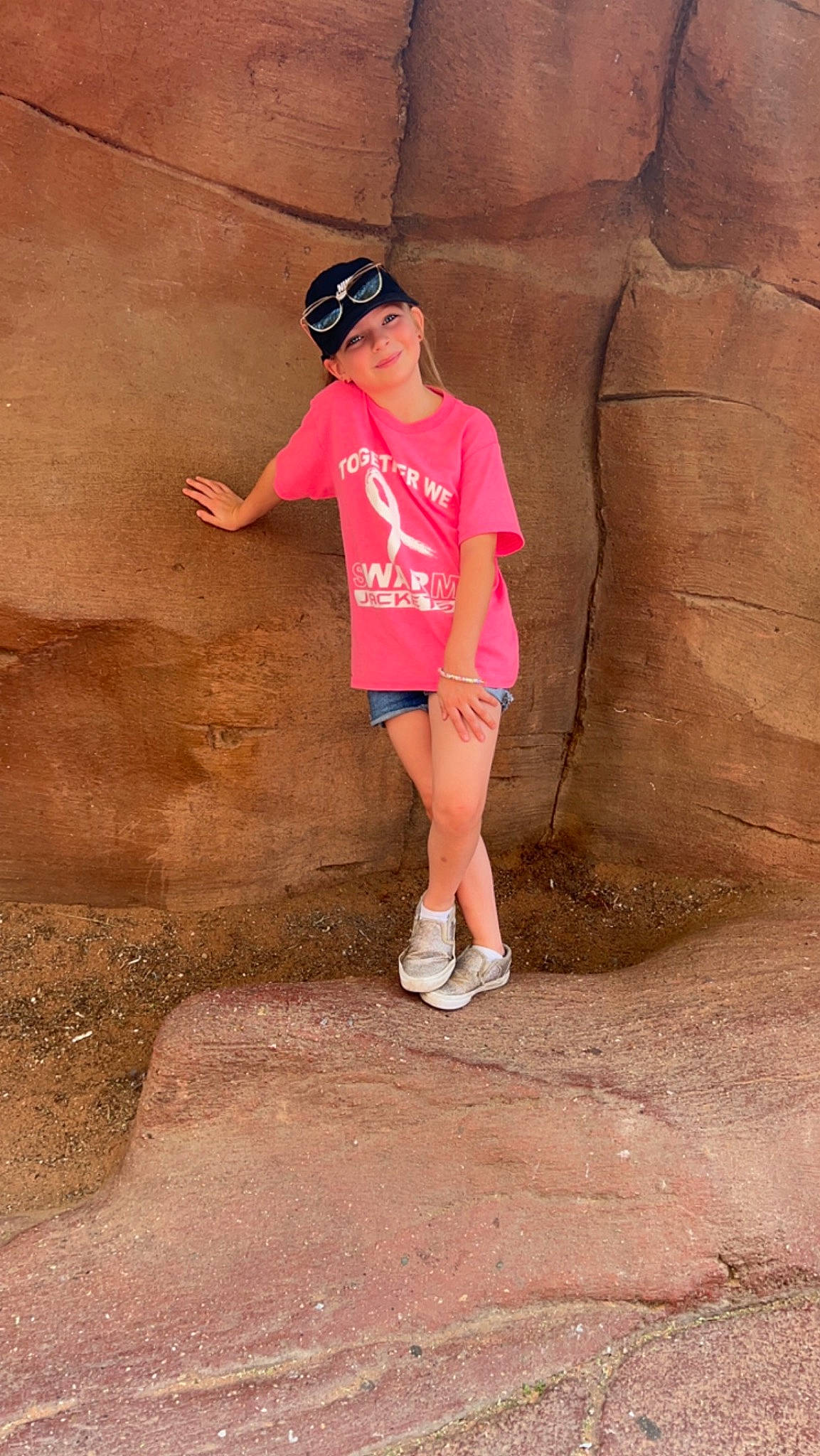 Delanie joined the competition — help win amazing prizes! baseball_cap, cap, eyewear, flash_photography, fun, happy, hat, headwear, human_leg, joy, landscape, leg, leisure, magenta, person, recreation, shorts, sneakers, soil, sunglasses
