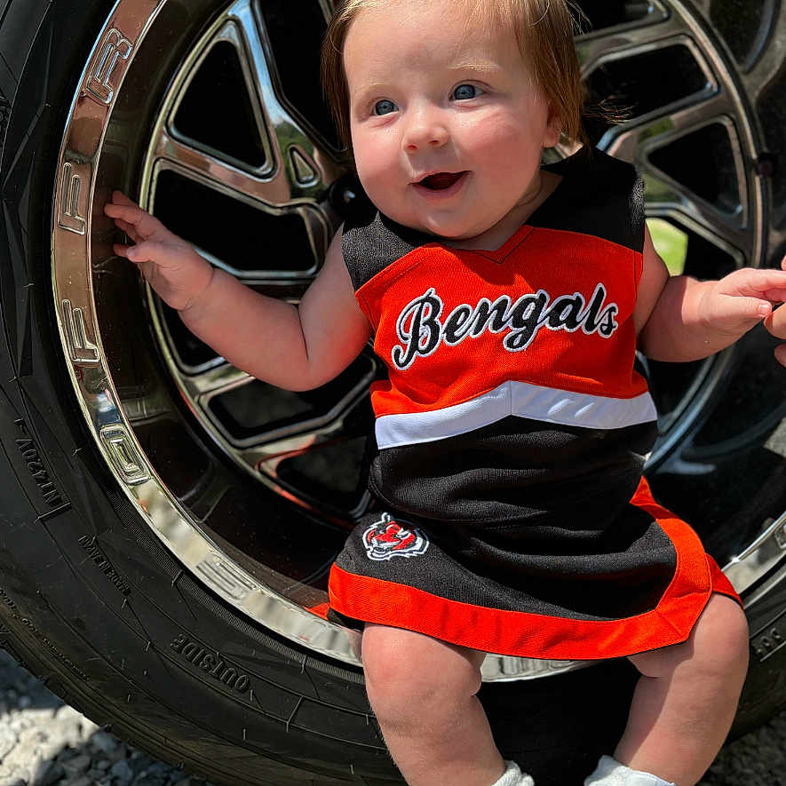 Gracelynn Kay is registered to the contest to win money with this photo: alloywheel, baby, car, carwheel, clothing, face, footwear, head, machine, person, photography, portrait, shoe, shorts, sneaker, spoke, tire, transportation, vehicle, wheel