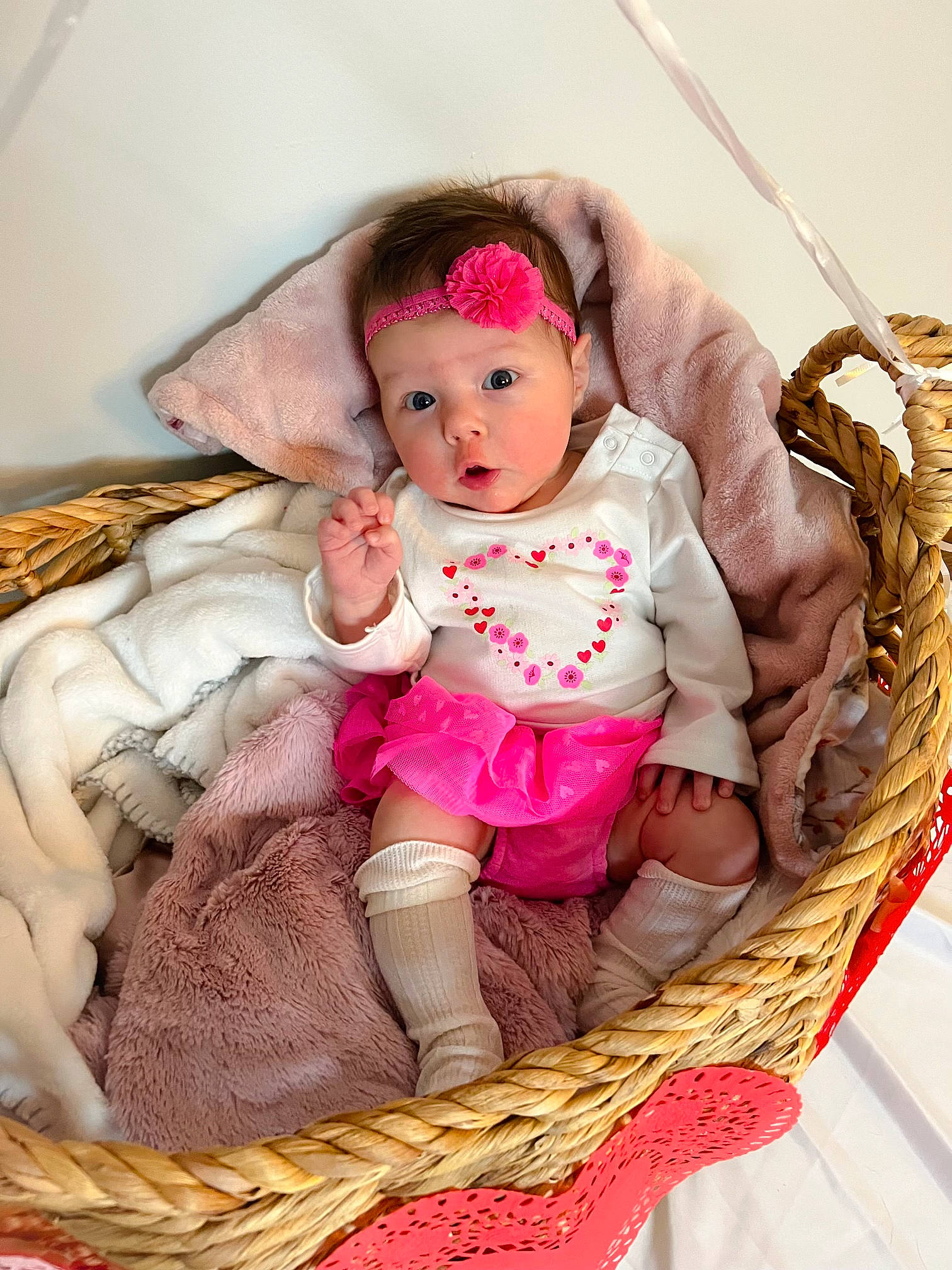 Madelyn is registered to the contest to win money with this photo: baby, baby_products, baby_toddler_clothing, bag, basket, cap, child, comfort, doll, eyelash, fashion_accessory, linens, magenta, pattern, person, sitting, skin, textile, toddler, toy
