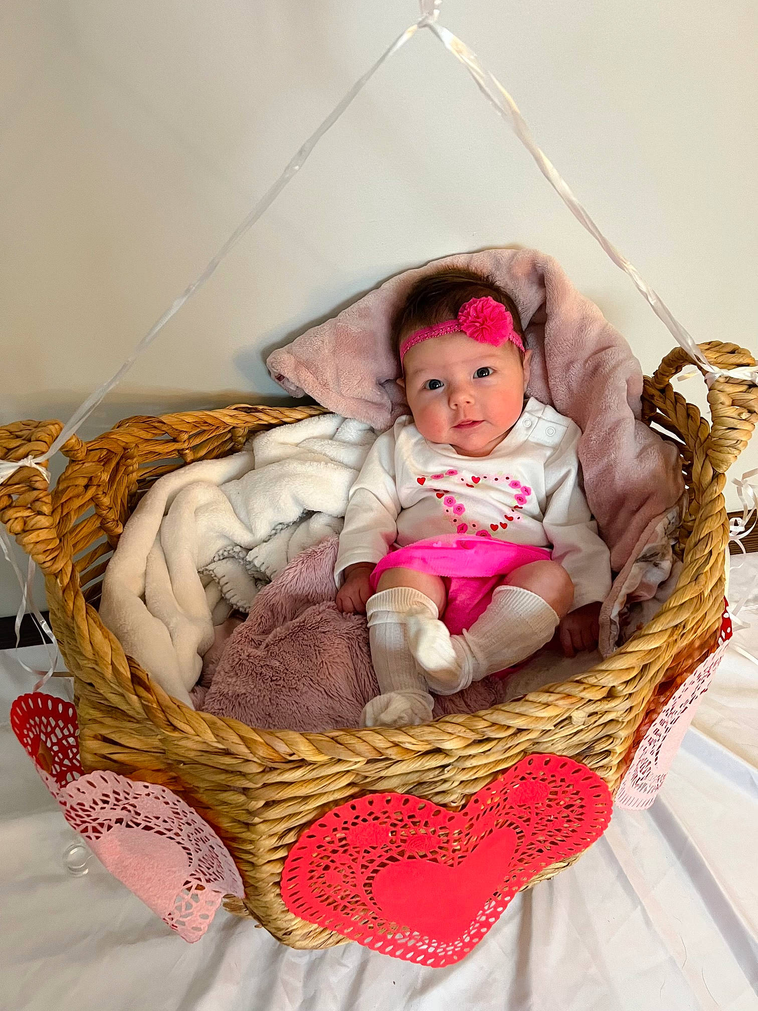 Madelyn is registered to the contest to win money with this photo: baby, baby_carriage, baby_products, baby_sleeping, baby_toddler_clothing, bag, basket, child, comfort, fashion_accessory, infant_bed, linens, person, room, sitting, storage_basket, textile, toddler, toy, wicker