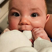 Amoura is registered to the contest to win money with this photo: baby, close_up, face, eyes, hand, infant, plush_toy, soft_texture, cute, cheeks, indoor, child, skin, curious, mouth, expression, person, young, fingers, adorable