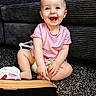 baby, carpet, child, couch, cute, face, floor, hands, happy, head, home, indoor, infant, legs, person, pink_shirt, playtime, sitting, smiling, toys