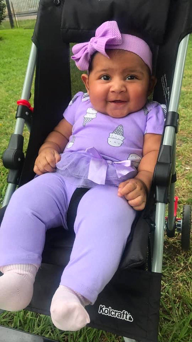Esperanza is registered to the contest to win money with this photo: baby, baby_carriage, baby_products, child, headwear, outdoor_play_equipment, person, play, playground, product, purple, swing, toddler