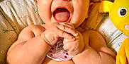 Delaney is registered to the contest to win money with this photo: baby, laughing, pacifier, blanket, plush_toy, yellow, happy, child, infant, cute, smiling, hands, face, cozy, bed, soft, comfort, playful, joy, indoors