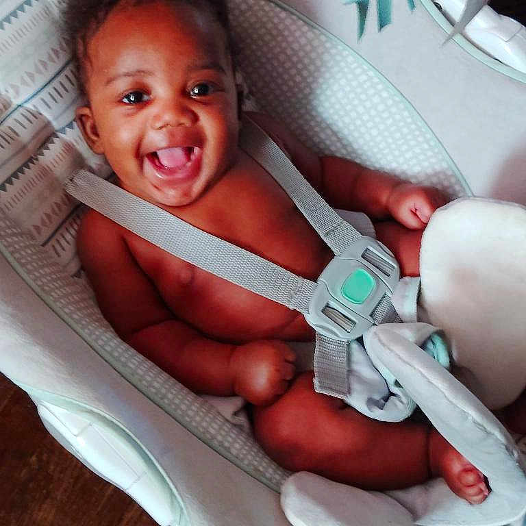 Kirby is registered to the contest to win money with this photo: baby, baby_seat, child, comfort, cushion, cute, expression, happy, human, indoors, infant, joy, newborn, person, portrait, seat, skin, smiling, straps, young
