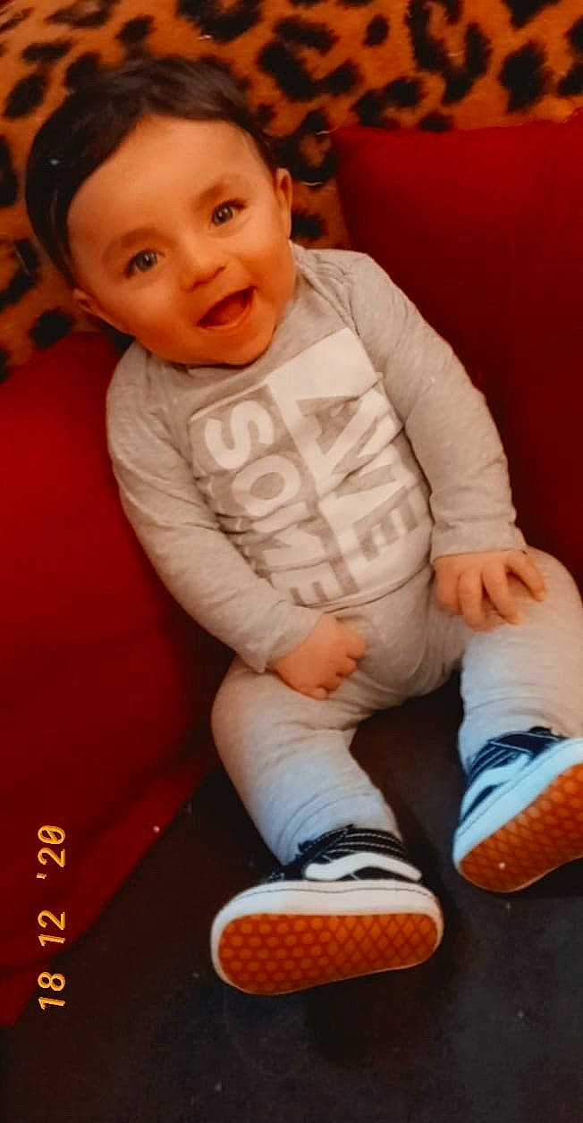 Juan is registered to the contest to win money with this photo: baby, baby_toddler_clothing, black, cheek, child, eye, face, finger, flooring, footwear, happy, head, mammal, person, product, skin, sleeve, smile, thigh, toddler