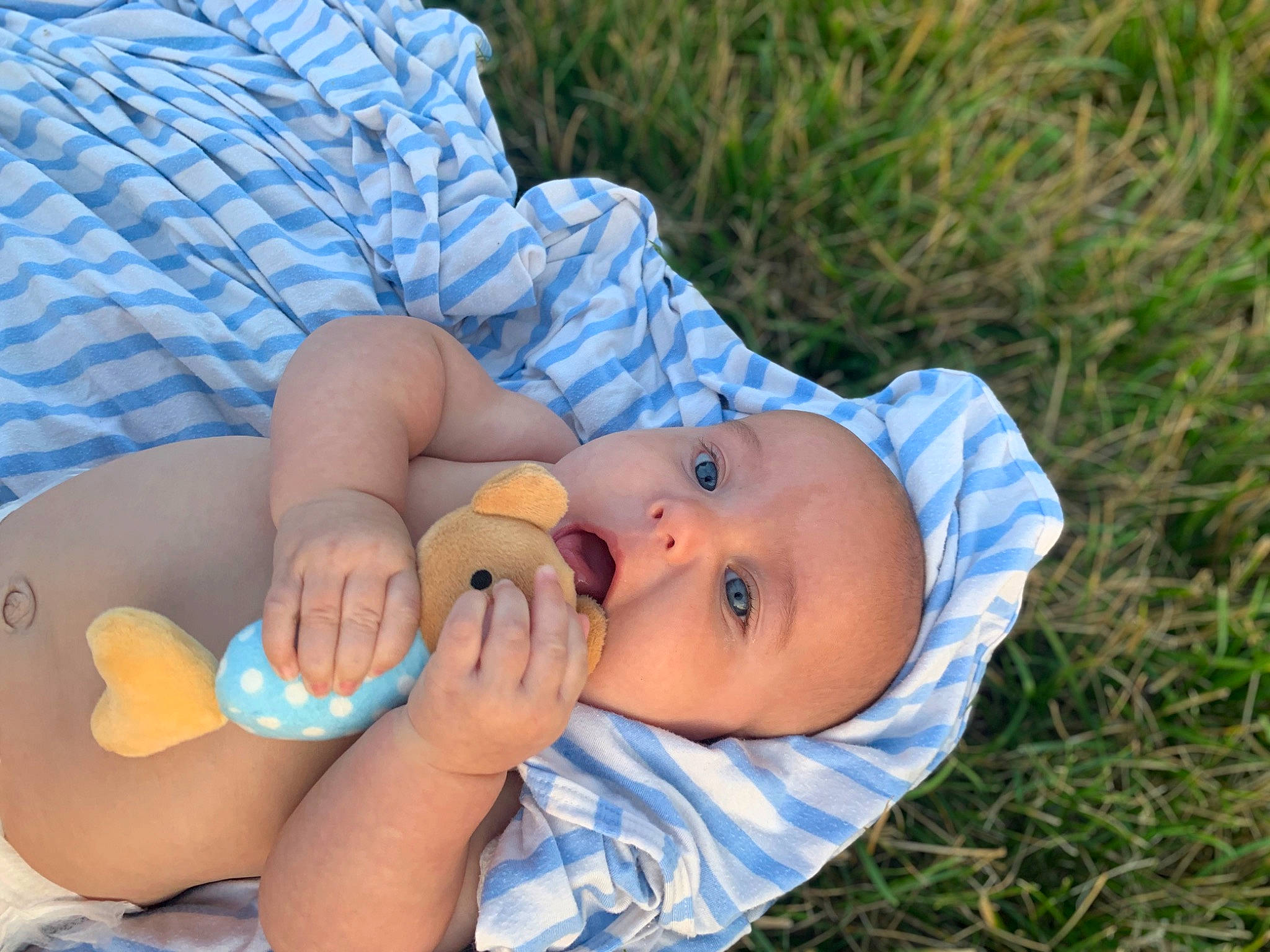 Everleigh Jean is registered to the contest to win money with this photo: baby, baby_products, baby_toddler_clothing, child, comfort, finger, foot, grass, hand, headwear, nail, pattern, person, plant, portrait_photography, sitting, thumb, toddler, tree