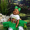 Aurra is registered to the contest to win money with this photo: baby, tutu, green_bow, smiling, toy_frog, crown, flowers, grass, pond, lilypads, white_tights, sitting, happy, portrait, headband, cute, outdoor_scene, child, playful, costume