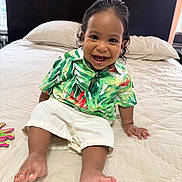 Cairo Rosario joined the competition — help win amazing prizes! toddler, child, smiling, sitting, bed, shirt, shorts, barefoot, indoors, headboard, pillow, curtains, happy, person, portrait, cute, young_child, home, natural_light, clothing