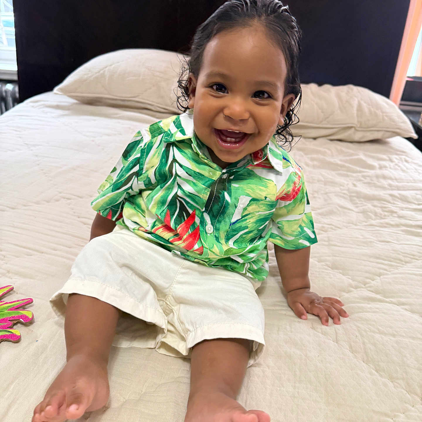 Cairo Rosario joined the competition — help win amazing prizes! toddler, child, smiling, sitting, bed, shirt, shorts, barefoot, indoors, headboard, pillow, curtains, happy, person, portrait, cute, young_child, home, natural_light, clothing
