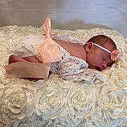 Blakely is registered to the contest to win money with this photo: baby, bed, bedroom, blanket, clothing, cushion, face, furniture, hat, head, homedecor, indoors, infantbed, newborn, person, photography, pillow, portrait, room, sleeping