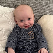 Parker joined the competition — help win amazing prizes! baby, child, clothing, comfort, couch, cushion, cute, face, hand, happy, indoors, infant, person, portrait, sitting, smile, soft, striped, teddy_bear, young
