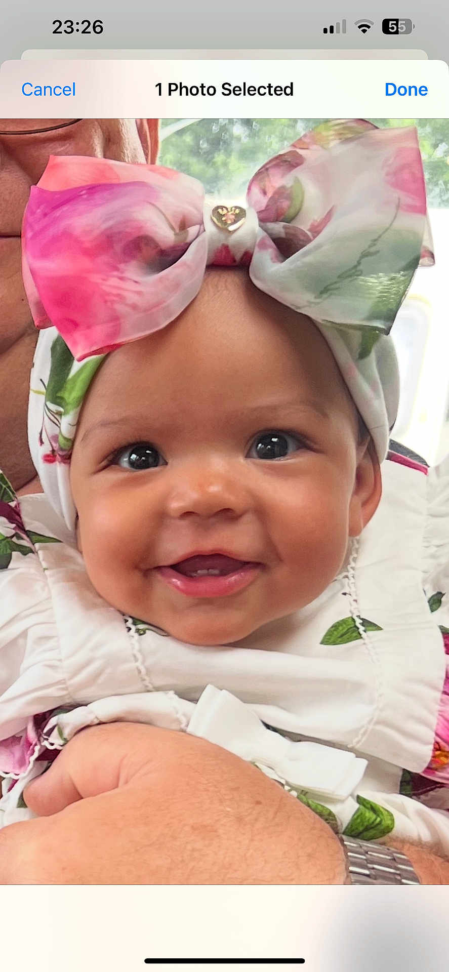 Anastasia is registered to the contest to win money with this photo: baby, child, smiling, face, headwear, bow, flower_pattern, white_clothing, infant, cute, portrait, happy, human_hand, adult, holding, skin, closeup, indoor, person, expression