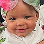 baby, child, smiling, face, headband, bow, flower, hand, person, portrait, cute, white_clothing, floral_pattern, infant, skin, eyes, happy, closeup, outdoor, baby_girl