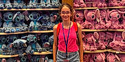 Eliana is registered to the contest to win money with this photo: accessories, bag, clothing, face, female, footwear, girl, glasses, head, pants, person, photography, portrait, pottery, shelf, shoe, shorts, sneaker, t_shirt, teen