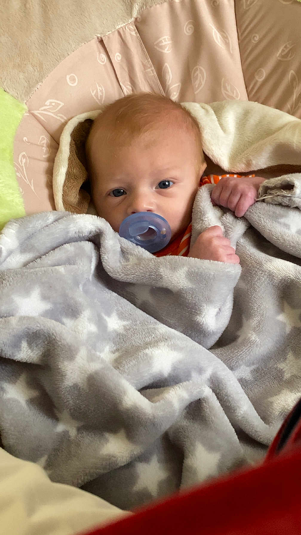 Ryder joined the competition — help win amazing prizes! baby, pacifier, blanket, star_pattern, bed, bedding, infant, wrapped, cozy, soft, sleepy, cute, child, face, head, hand, comfort, rest, indoors, portrait