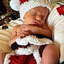Atlas joined the competition — help win amazing prizes! baby, sleeping, santa_hat, blanket, christmas_tree, holiday, cozy, indoor, infant, festive, decorations, cushion, peaceful, cute, child, portrait, soft, warm, holiday_season, relaxation