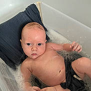 Tristan joined the competition — help win amazing prizes! baby, bath, bubble, water, plastic_tub, hand, skin, pillow, cloth, infant, relaxing, child, person, cute, indoors, cleaning, wet, face, eyes, expression
