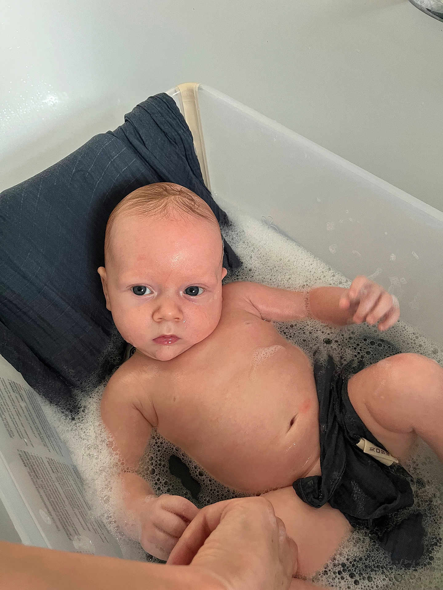 Tristan joined the competition — help win amazing prizes! baby, bath, bubble, water, plastic_tub, hand, skin, pillow, cloth, infant, relaxing, child, person, cute, indoors, cleaning, wet, face, eyes, expression