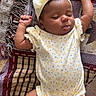 Atlantis is registered to the contest to win money with this photo: baby, sleeping, headband, onesie, blanket, pattern, infant, cute, peaceful, clothing, soft, hands_up, footwear, resting, indoors, child, adorable, portrait, toddler, sleep