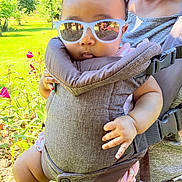 Winta joined the competition — help win amazing prizes! baby, sunglasses, baby_carrier, adult, outdoor, greenery, flowers, tongue_out, casual_clothing, sunlight, person, child, nature, summer, reflection, closeup, cute, playful, portrait, happy